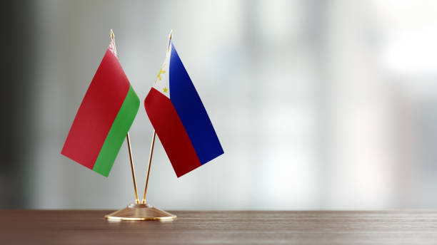 istock Belarus And Philippines Flag Pair On A Desk Over Defocused Background 951657108