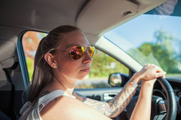 istock young woman with sunglasses in a car 951657302