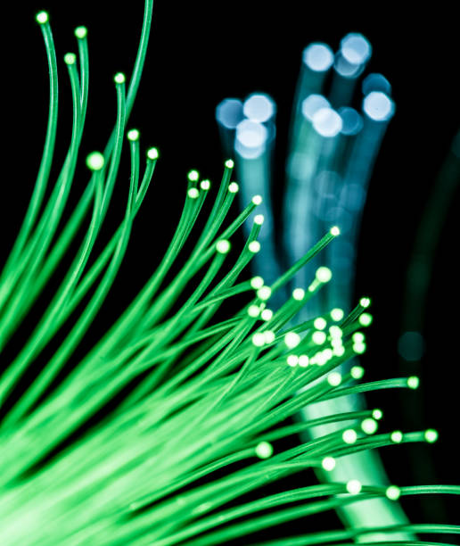 istock Bundle of optical fibers with green light. 951658250