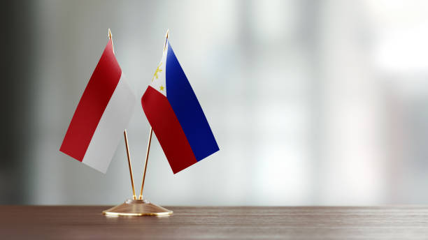 istock Indonesian And Philippines Flag Pair On A Desk Over Defocused Background 951658322