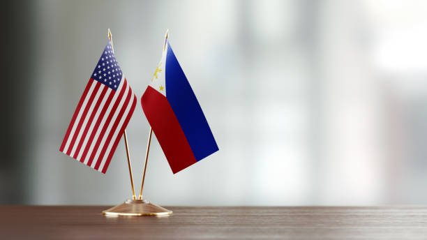 istock American And Philippines Flag Pair On A Desk Over Defocused Background 951658662