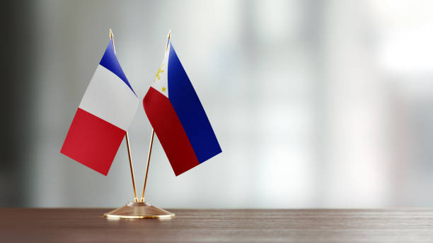 istock French And Philippines Flag Pair On A Desk Over Defocused Background 951658832