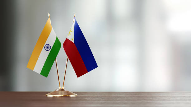 istock Indian And Philippines Flag Pair On A Desk Over Defocused Background 951659512
