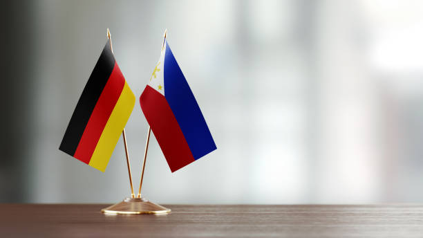 istock German And Philippines Flag Pair On A Desk Over Defocused Background 951659822