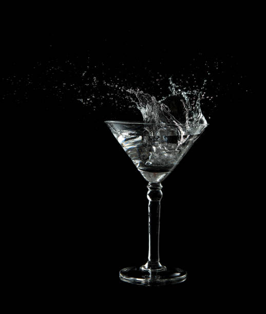 istock Martini glass low key photo in studio on black background and a water plash 951661894