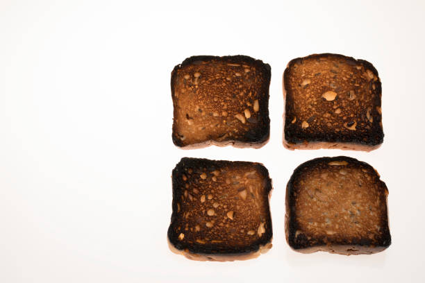 istock Burned bread with seeds isolated on white background 951662170