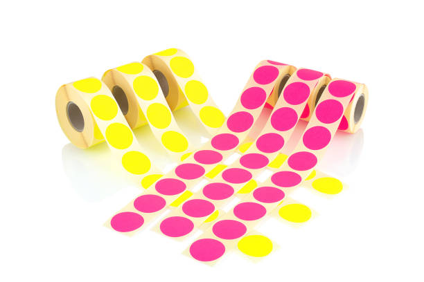 istock Colored label rolls isolated on white background with shadow reflection. Color reels of labels for printers. Labels for direct thermal or thermal transfer printing. Yellow and pink labels background. 951667038