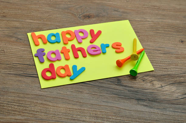 istock A note with the word happy fathers day and golf tees 951668284