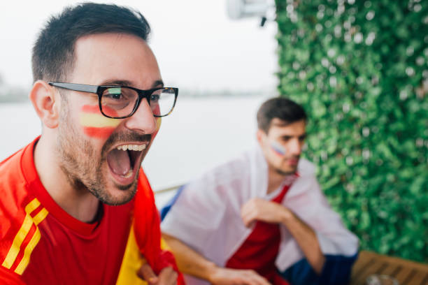istock Excited Spanish soccer supporter shouting while watching a game with a friend 951668406