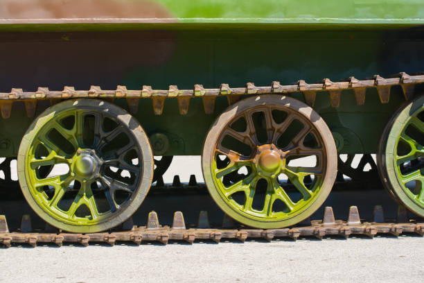 Part of a continuous track on a military amphibious vehicle. The vehicle has a verdant camouflage scheme on it.