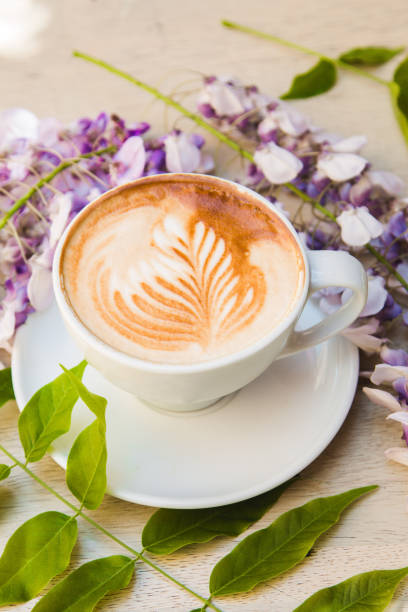 istock Decorated coffee cappuccino surrounded with flowers 951674680