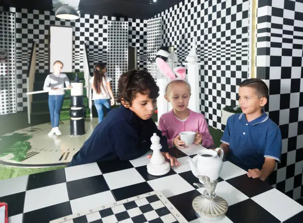 Photo of friends play in quest room in chess style