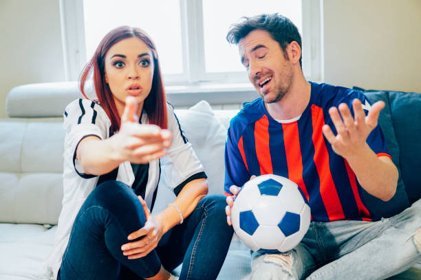 istock Couple watching soccer game on TV 951675424