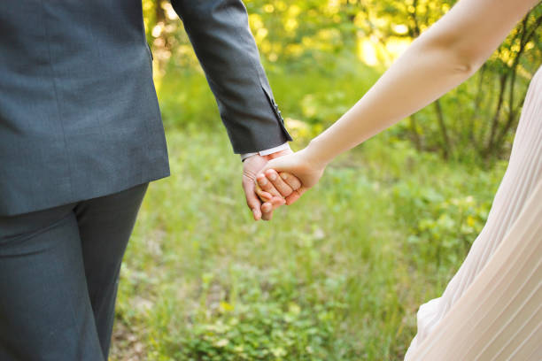 istock Hands of a loving couple. Wedding ring 951675860