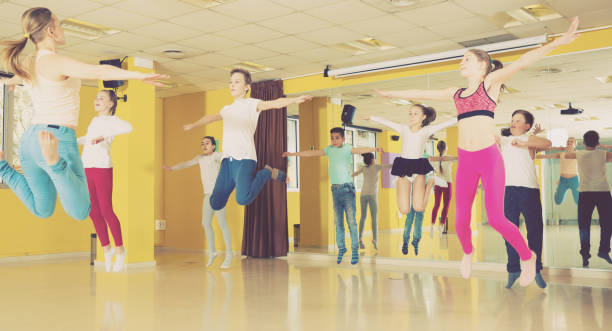 istock Tweens jumping with female coach in choreography class 951676644