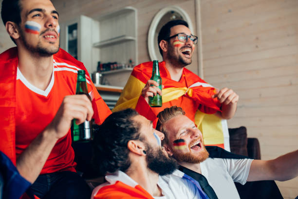 istock Male football supporters laughing 951677126