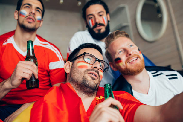 istock Male football supporters watching game and talking 951677266