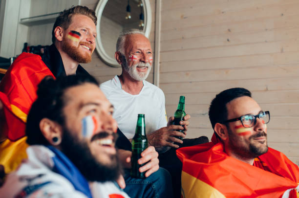 istock Happy people watching soccer game and drinking beer 951677434
