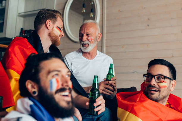 istock People talking and watching soccer championship 951677436