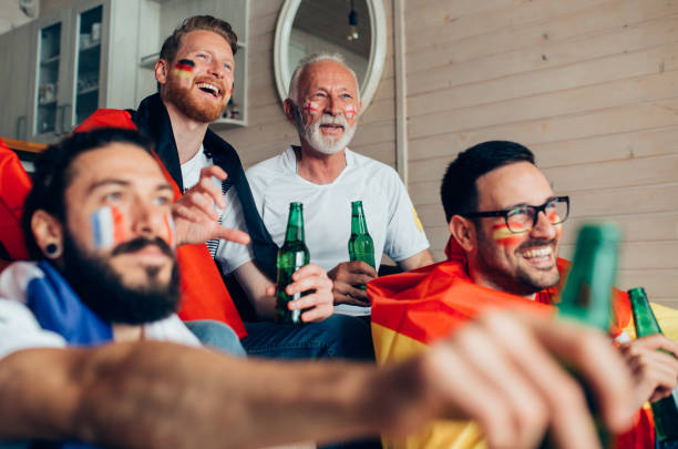istock Friends drinking beer and watching soccer game 951677440