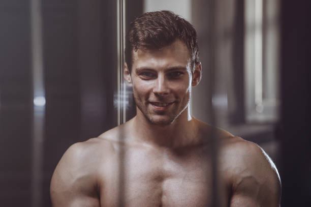 istock handsome strong bodybuilder athletic men pumping up muscles with dumbbells 951677584