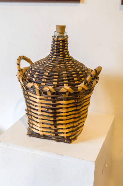 istock 10 L glass bottle in a wicker basket 951677816