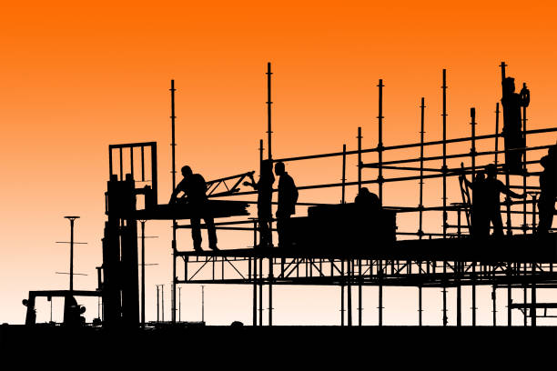 istock Silhouette of construction workers working on scaffolding 951678028