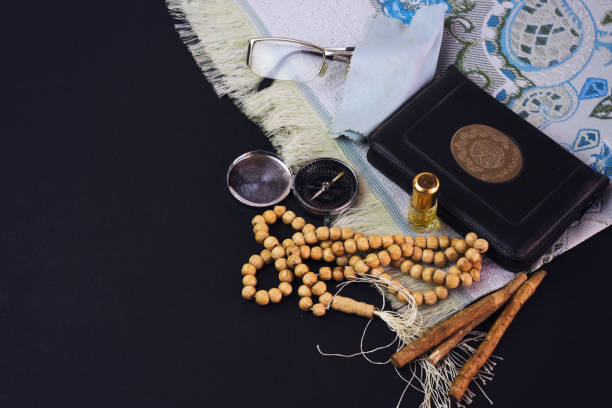 istock prayer beads, siwak, perfume and book, muslim compass 951678444