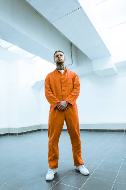istock bottom view of tattooed prisoner standing in prison cell 951679046