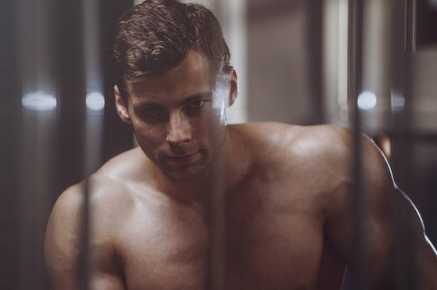istock handsome strong bodybuilder athletic men pumping up muscles with dumbbells 951679906