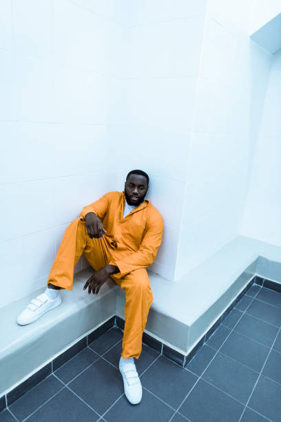 istock high angle view of african american prisoner sitting on bench 951680432