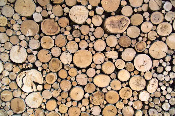 Sawn timber logs stacked for a wood burning stove. Close up in full frame and a horizontal format