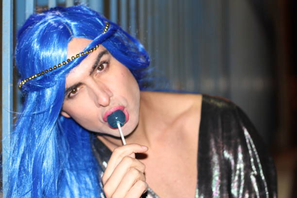 istock Transgender person eating blue lollipop with copyspace 951681268