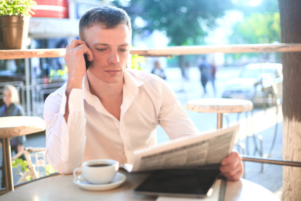 istock Young man drinking coffee in cafe and using phone. 951681684