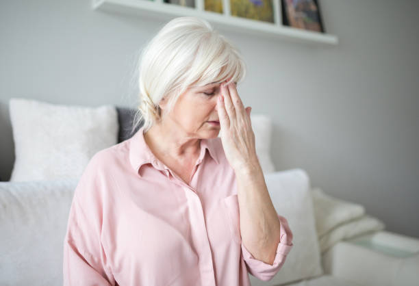istock Senior lady with migraine touching her forehead 951683792