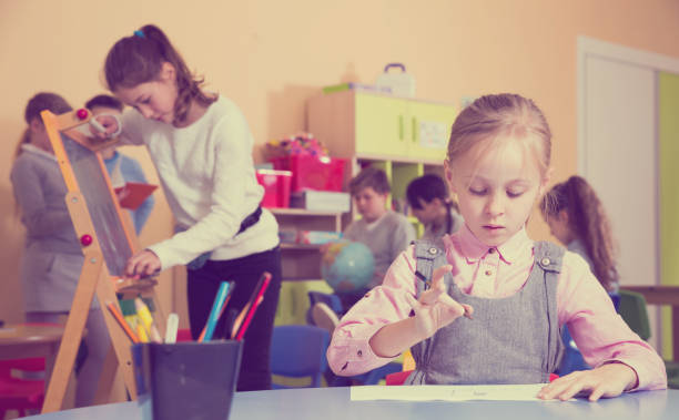 istock Girl drawing in schoolroom during break 951685636