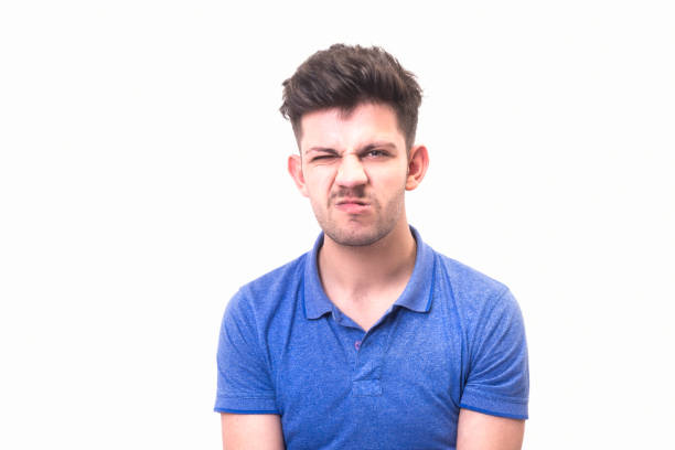 istock Portrait of cute young man making a face over white background 951687606