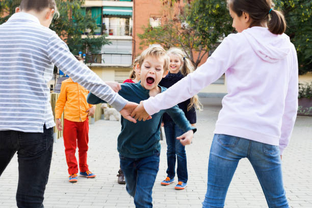 istock Junior school girls and boys playing octopus tag 951688024