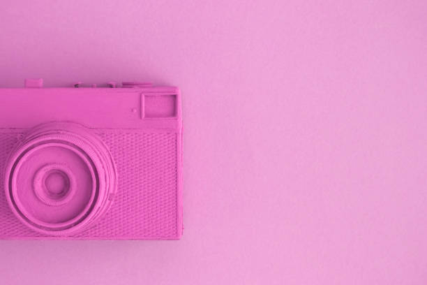 istock Flat lay of rose colored retro camera surrealism abstract concept 951688318