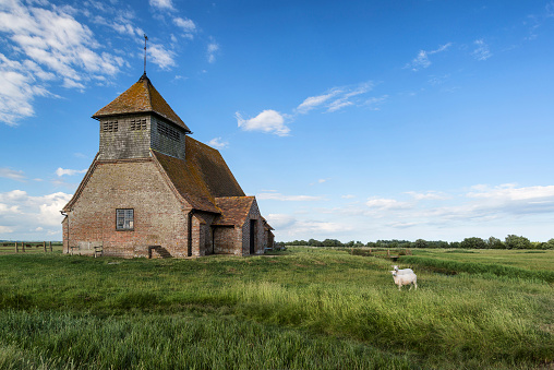 Ancient 13th Century derelict church in blue sky Summer landscape