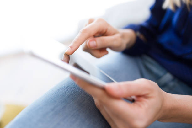istock Young woman using her digital tablet at home. 951690994
