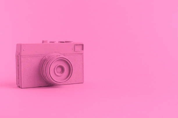istock Flat lay of rose colored retro camera surrealism abstract concept 951692484