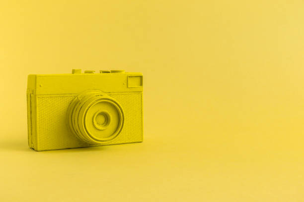 istock Flat lay of yellow colored retro camera surrealism abstract concept 951692578