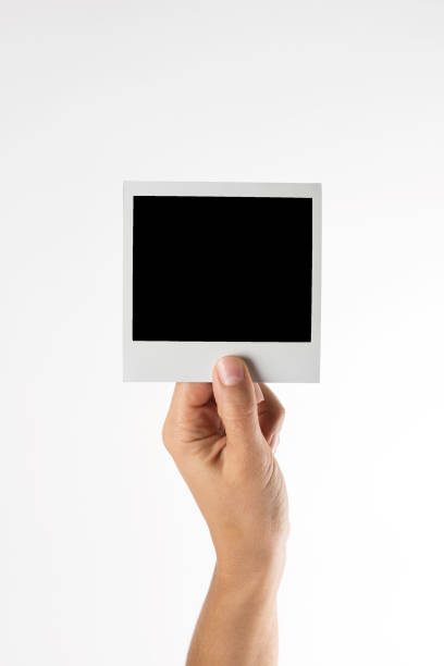 Empty Picture Hand which is holding single empty polaroid . holding photos stock pictures, royalty-free photos & images