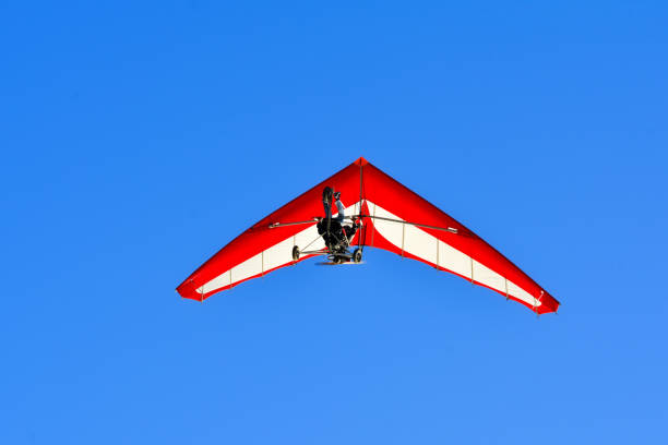istock The motorized hang glider in the blue sky 951693316