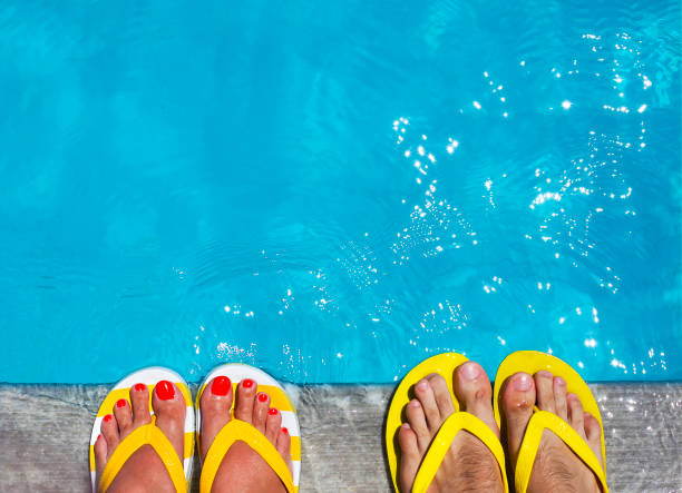 istock Feet in flip flops on stone background 951694036