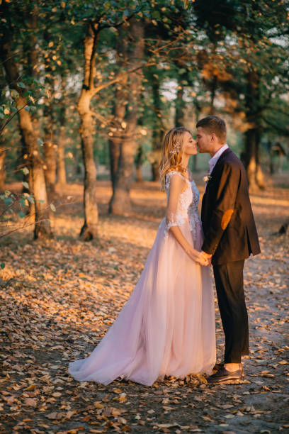 istock newlyweds walking in the woods at sunset 951694396