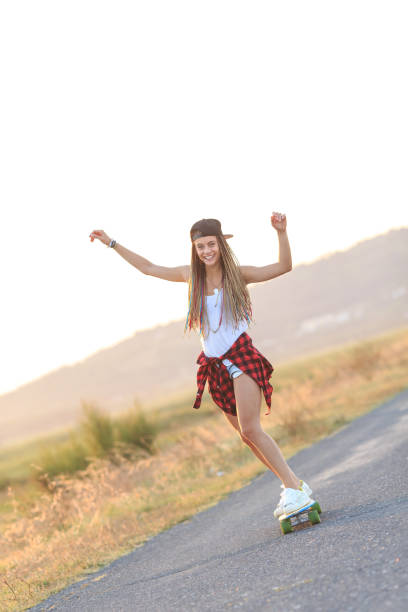 istock Smiling skater moving down on country road 951695302