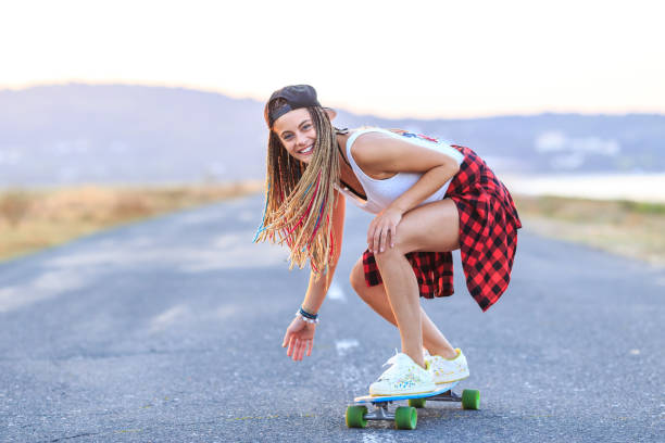 istock Smiling skater moving down on country road 951695310