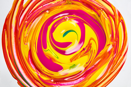 Yellow and orange paint mixed together in a circle
